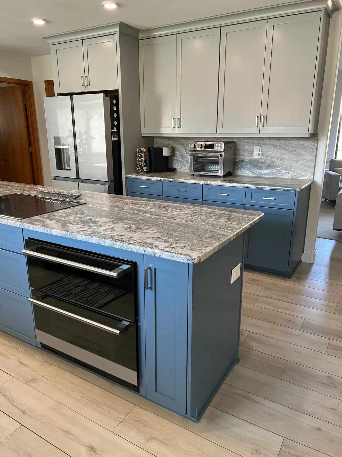 Leathered granite countertops with a crescent edge and radius corners on a blue kitchen island in Carson City