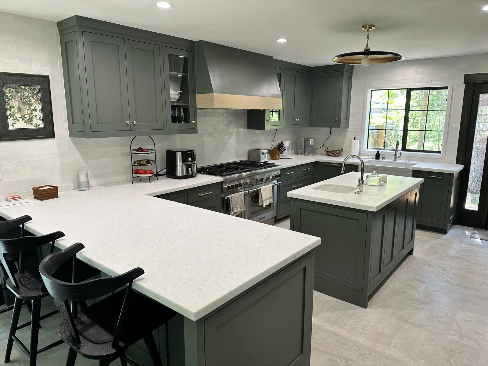 Honed white marble countertops with mitered edges on a kitchen island and peninsula in a Lake Tahoe home
