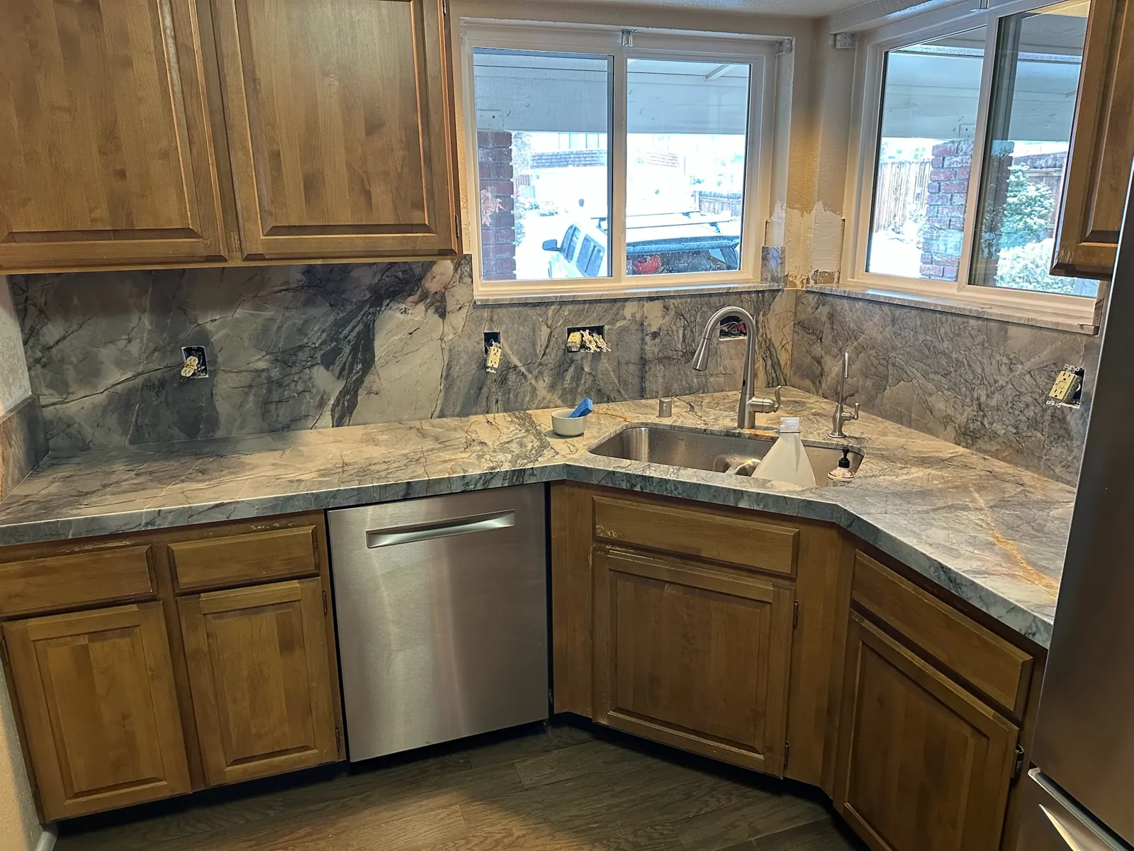 Ijen Blue quartzite countertops and full-height backsplash replacing old tile in a Reno kitchen with wood cabinets